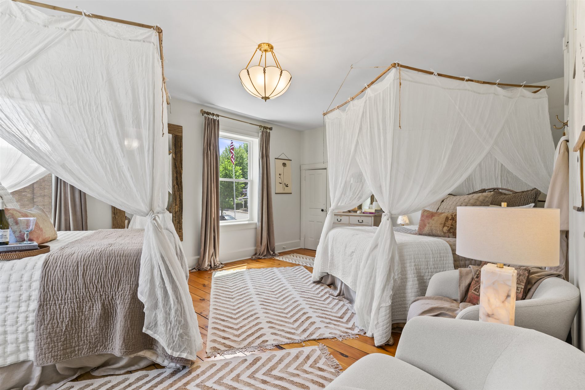 A serene canopy bedroom framed in soft white drapery