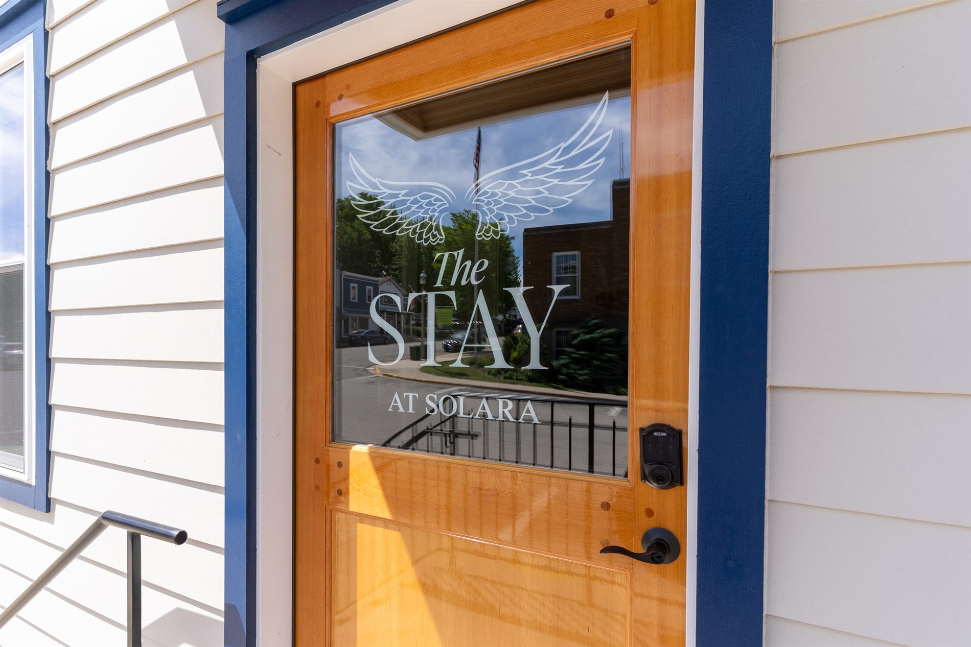 Welcome to The Stay — the wings-etched entrance