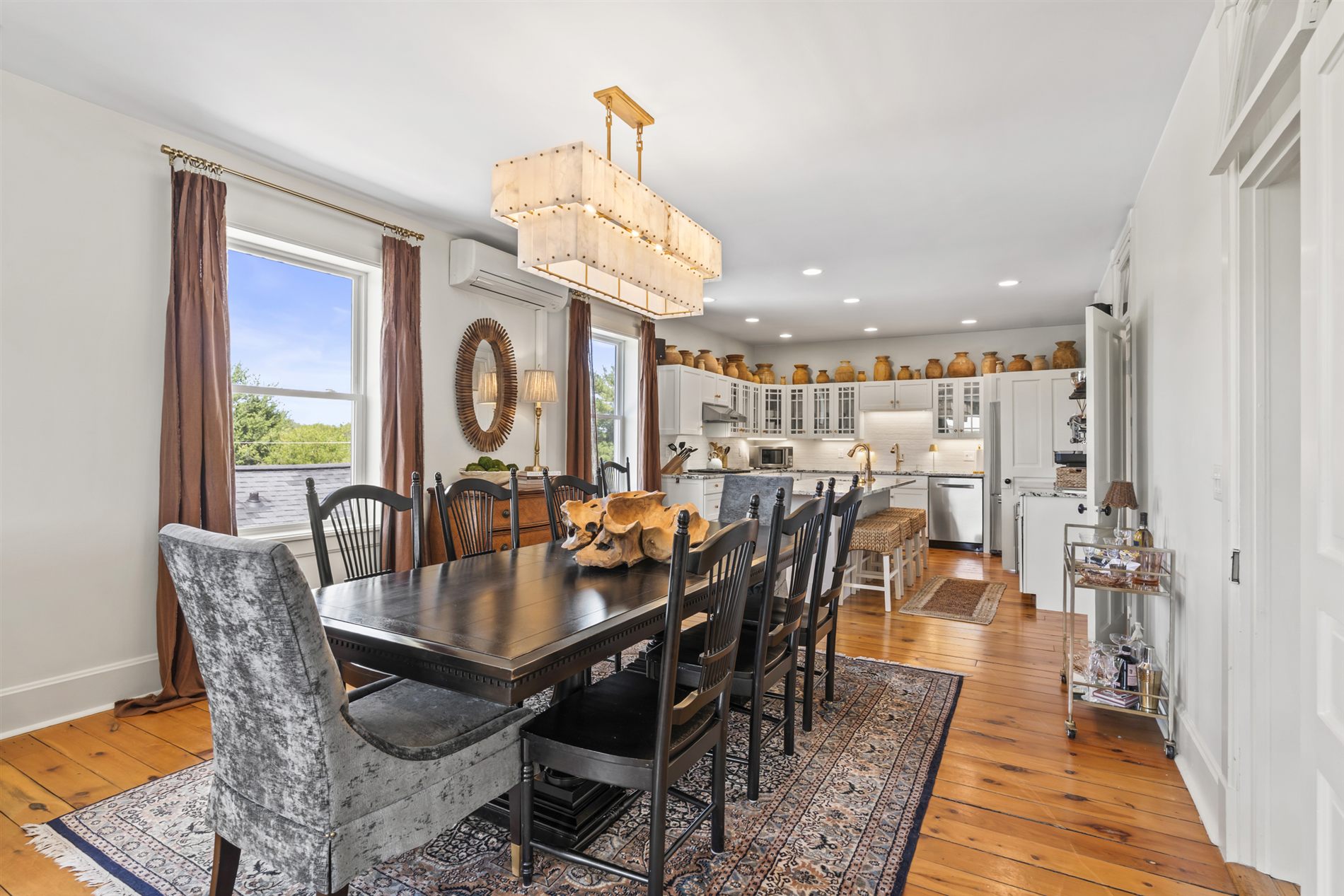 The dining room set beneath lakeside windows