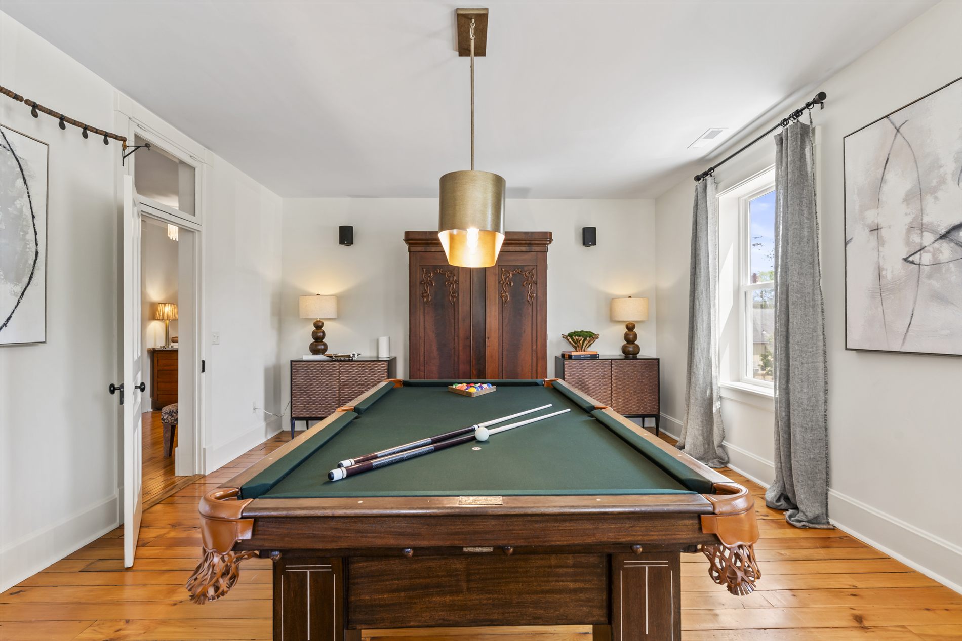 The open living space at The Stay, anchored by the restored 1910 billiards table